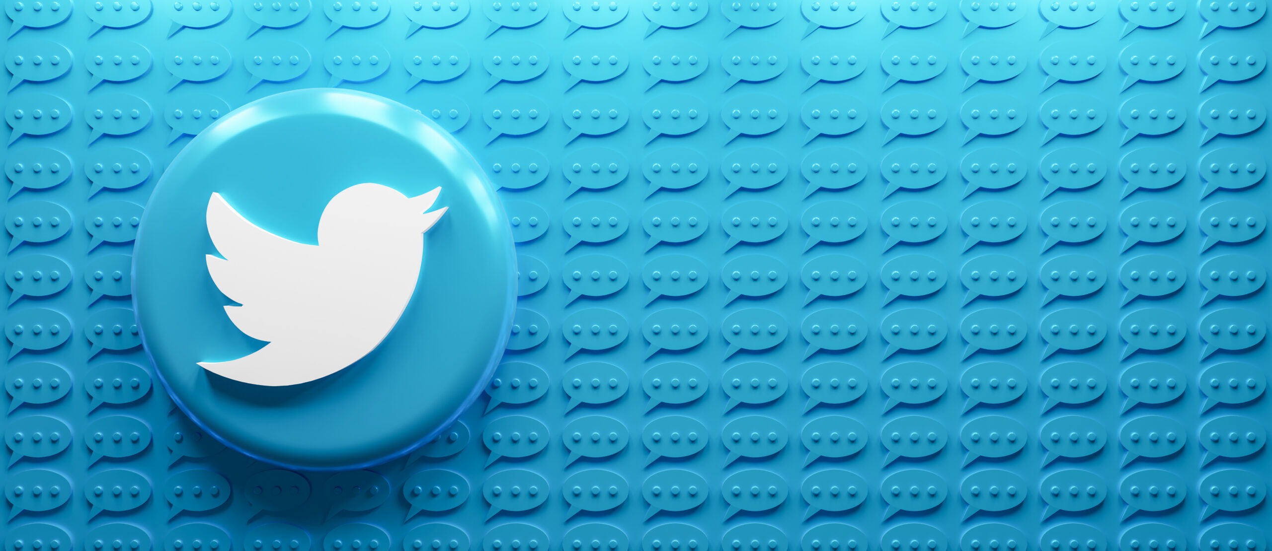 3D rending of Twitter logo with a the message symbol in blue spread all across the background