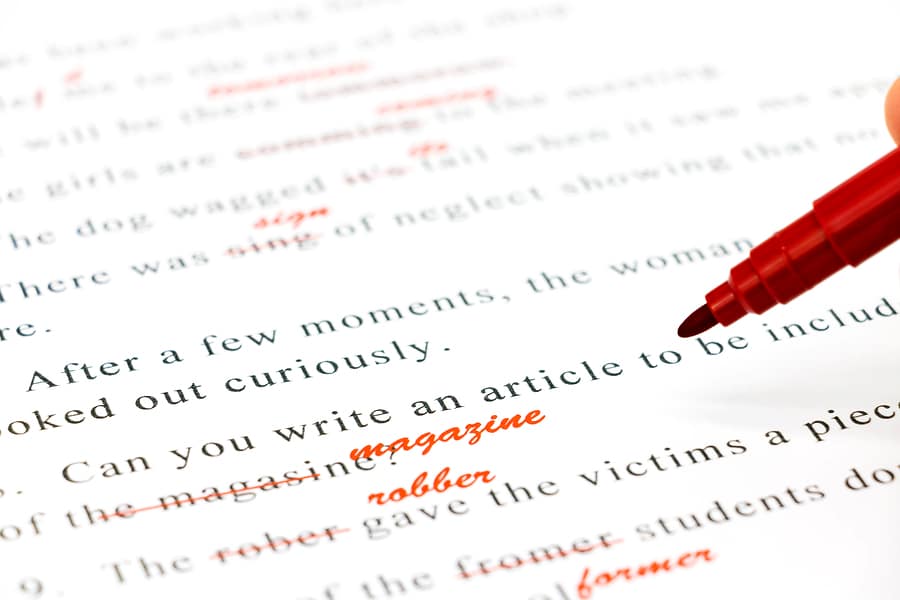 A closeup of words being edited with a red pen