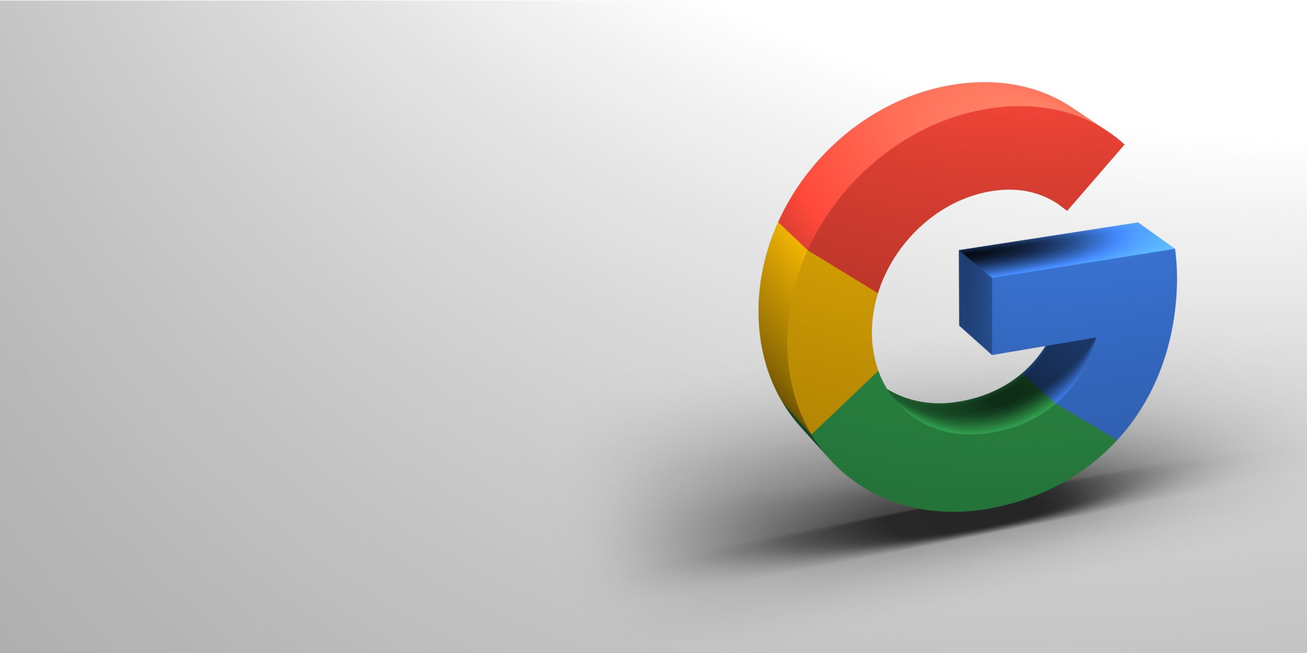 A 3D rendering of the Google logo on a white foreground, placed on the right hand side. 