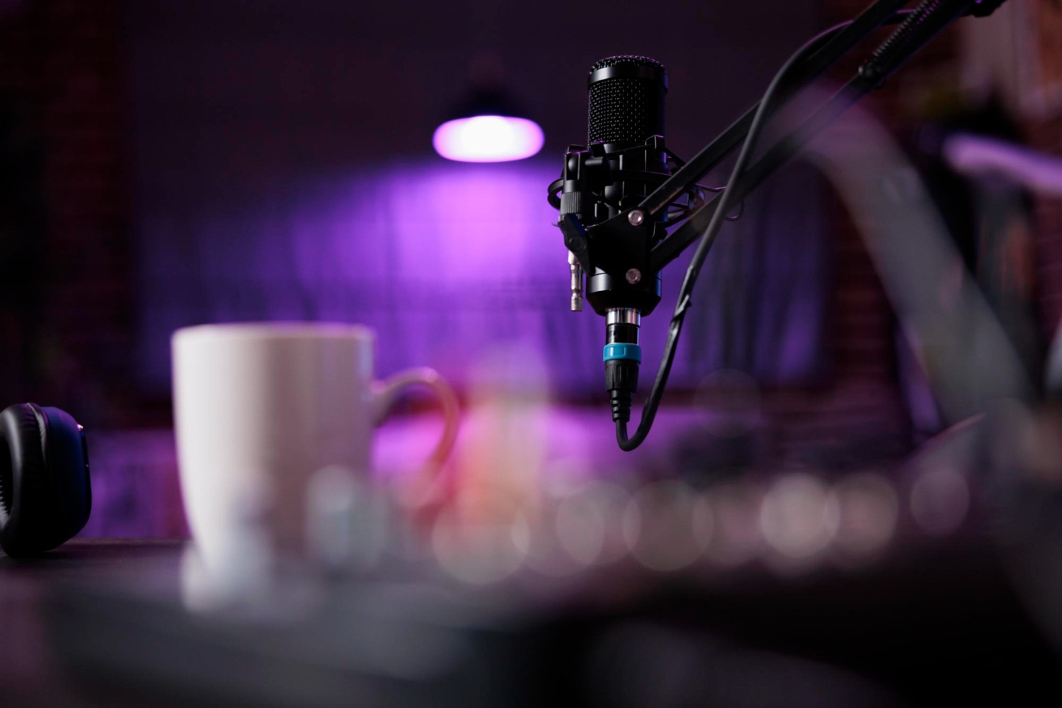 a recording microphone with a coffee mug behind it